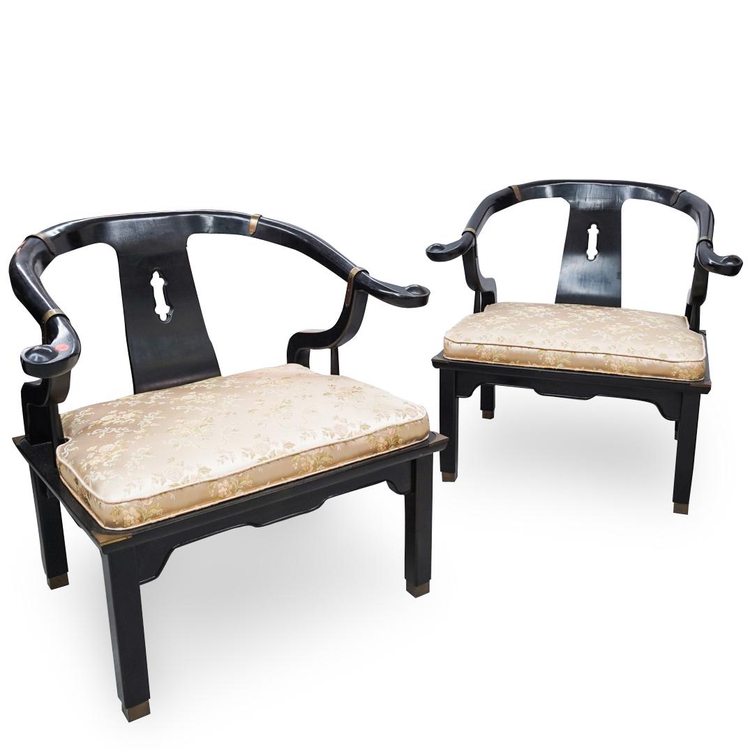 Pair Of Chinese Wooden Horse Shoe Chairs: DESCRIPTION: A pair of Chinese wooden chairs featuring in a horse shoe shape, the chairs are composed of black lacquer wood, accented by gilt brass hardware. Completed by two silk embroidered cushions