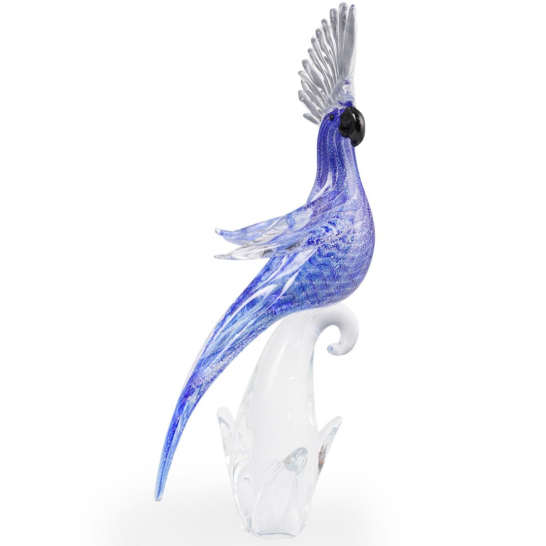 Oggetti Murano Glass Cockatoo: DESCRIPTION: An Oggetti Murano glass cockatoo features in deep blue hue with speckled white designs, sitting atop a clear glass base. Original Oggetti sticker was peeled off. CIRCA: 20th cent. ORIGIN: