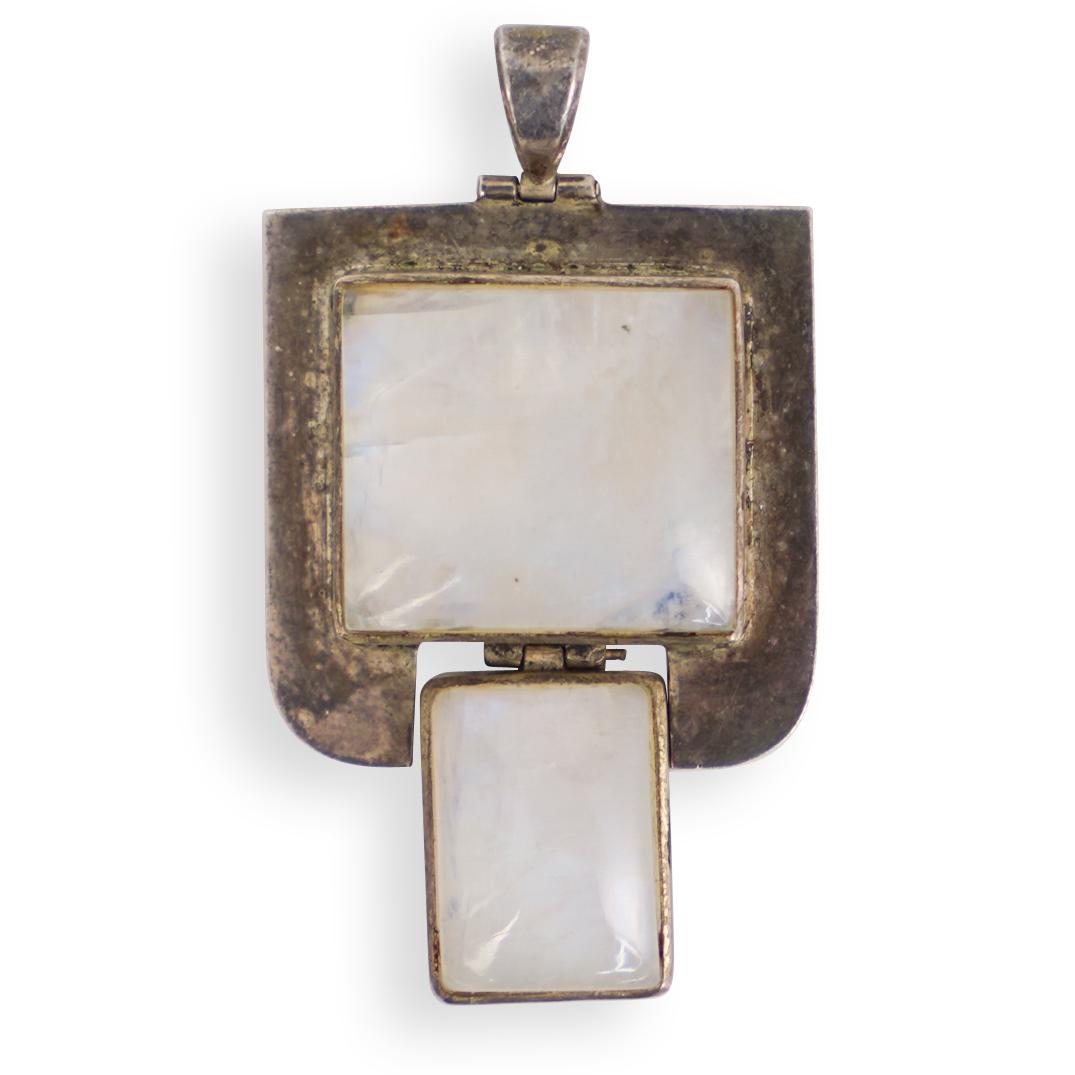 Art Studio Silver Moonstone Pendant: DESCRIPTION: Sterling silver pendant adorned with moon stone. Stamped on reverse. Total Weight:24 Grams CIRCA:20th Ct. ORIGIN:Continental DIMENSIONS: L:2.5" x W:1.75" Total Weight:24 Grams CONDITION: