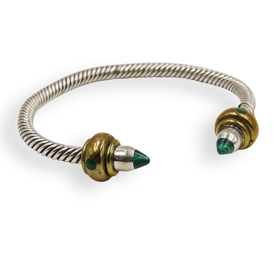 Mexican Sterling and Malachite Cuff: DESCRIPTION: A Bracelet cuff composed of a Strerling silver frame with an intertwining pattern, completed at each end with gilt tones and Malachite stone inserts. Marked along the interior "925" with