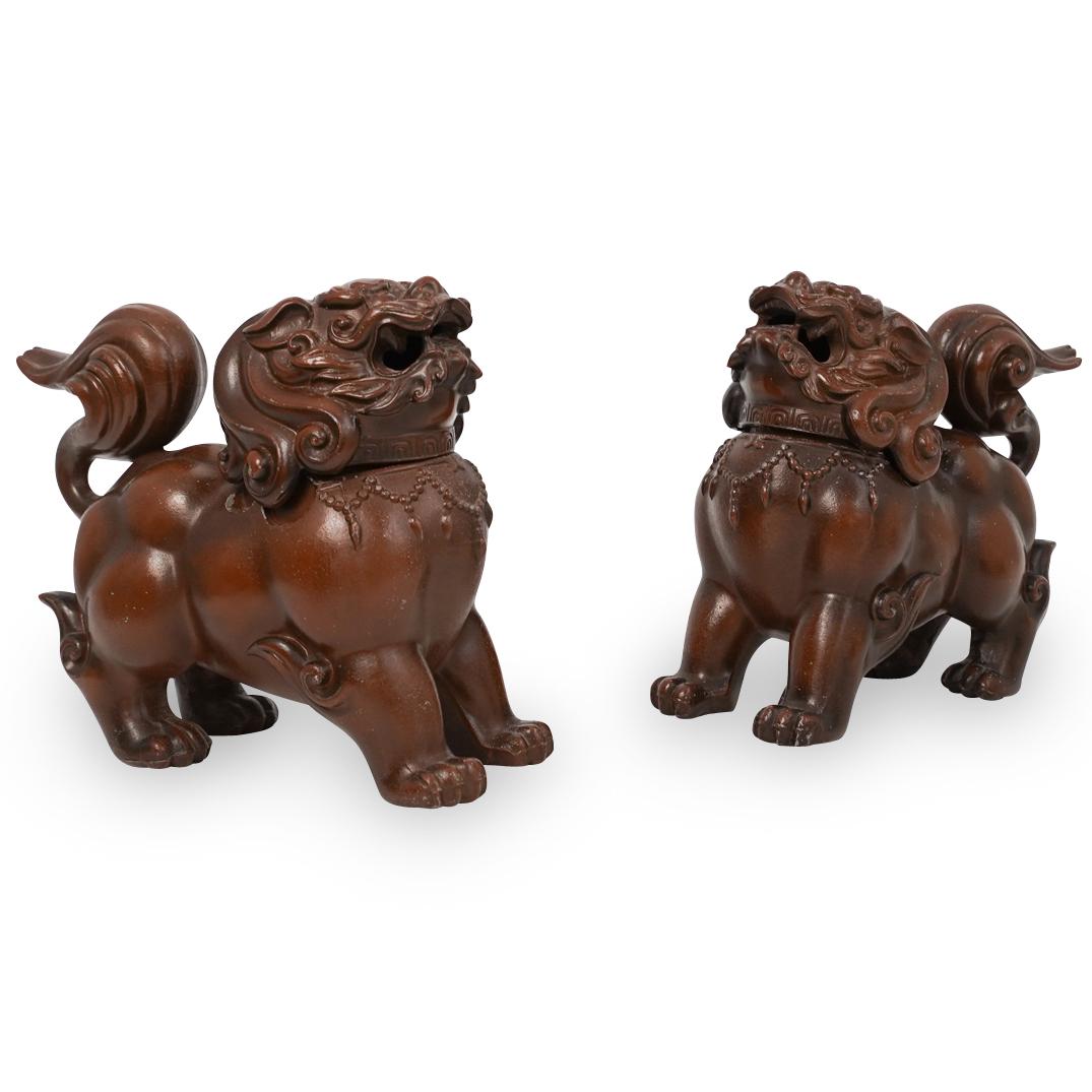 Vintage Chinese Pair Of Foo Dogs: DESCRIPTION: A vintage pair of Chinese foo dogs made of pot medal with removable heads in a dark brown bronze color patina. CIRCA: 1950s ORIGIN: China DIMENSIONS: H:6.5" L:6.5" D:3.5" CONDITION: Great