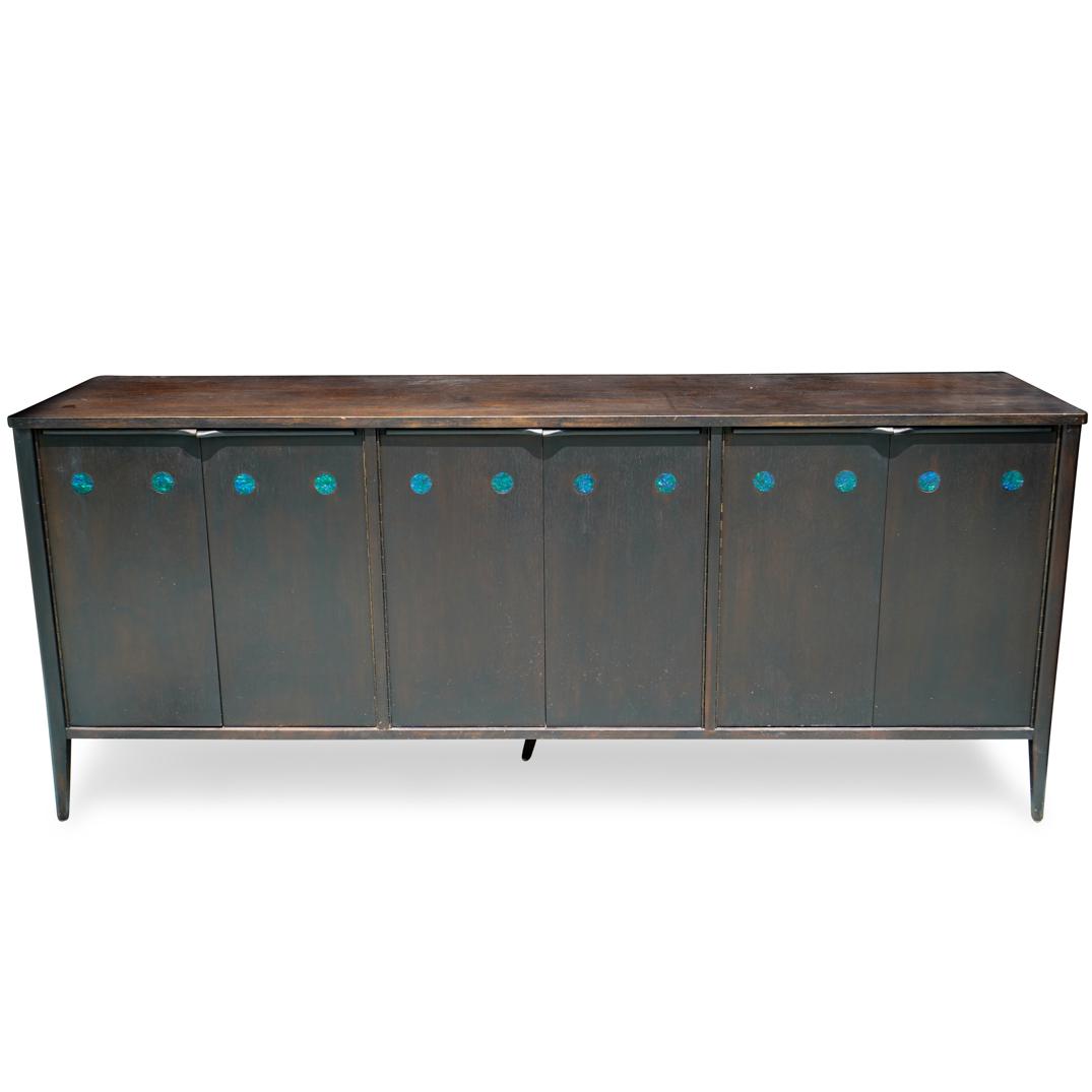 Mid Century Dark Wood Credenza: DESCRIPTION: Mid century dark wood credenza with iridescent resin circular accents. The Credenza features three cabinets with interior shelving, sticker along the back. CIRCA:20th Ct. ORIGIN: Continen