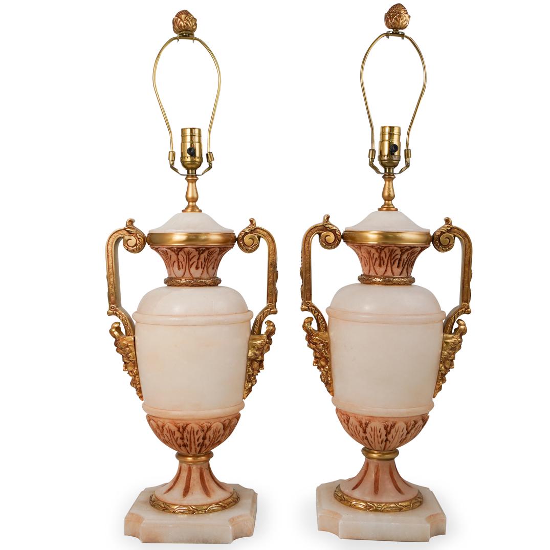 Pair Of Alabaster & Bronze Lamps: DESCRIPTION: A pair of lamps composed of alabaster with mounted gilt bronze figural handles and accents. Fitted for single bulb. CIRCA: 20th Ct. ORIGIN: Continental DIMENSIONS: H: 31.5" " x D: 10" CON