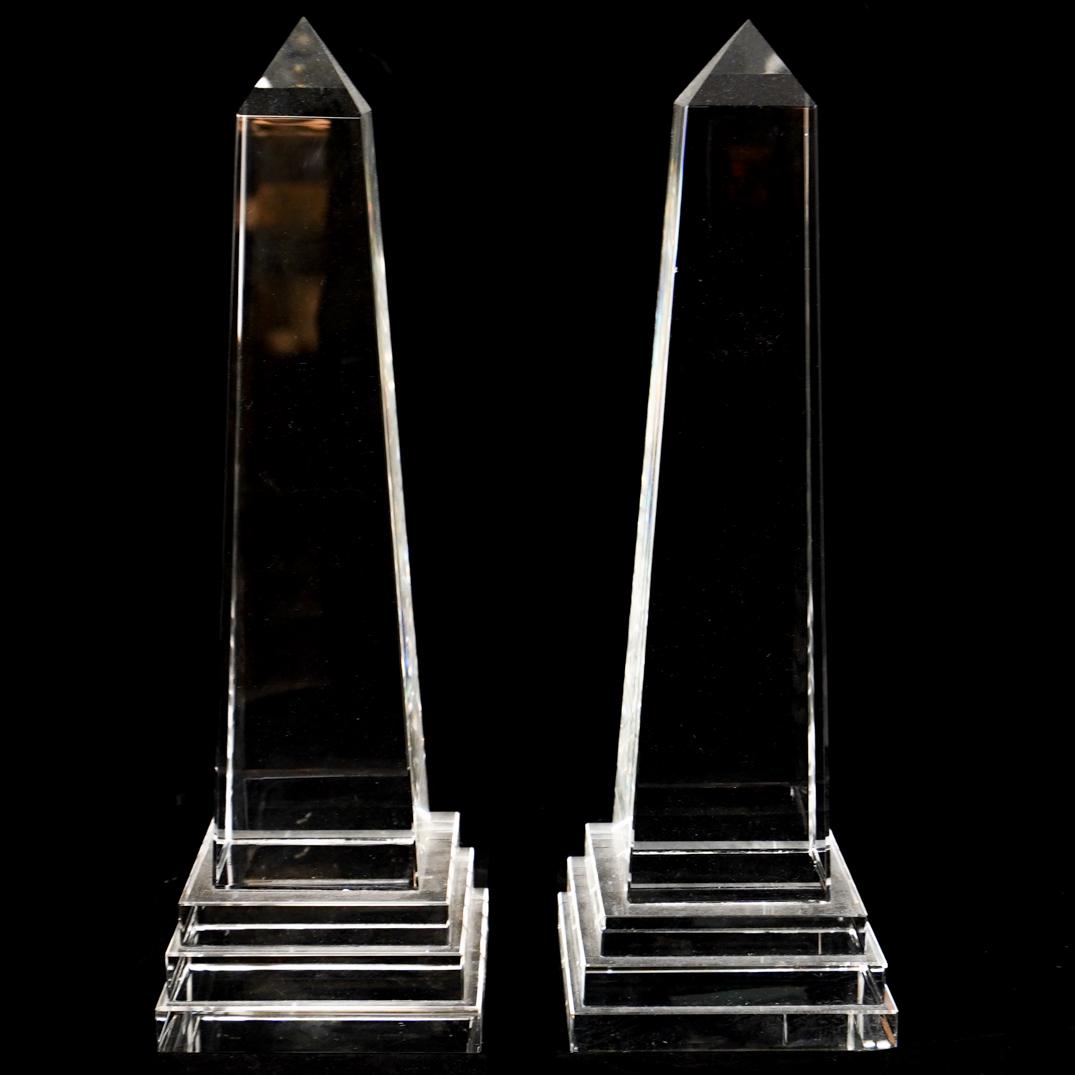 Pair Of Crystal Obelisks: DESCRIPTION: A pair of crystal obelisks. CIRCA: 20th Ct. ORIGIN: Continental DIMENSIONS: H: 13.75" x W: 4.25" x L: 4.25" CONDITION: Great condition. See lot description for details on item condition.