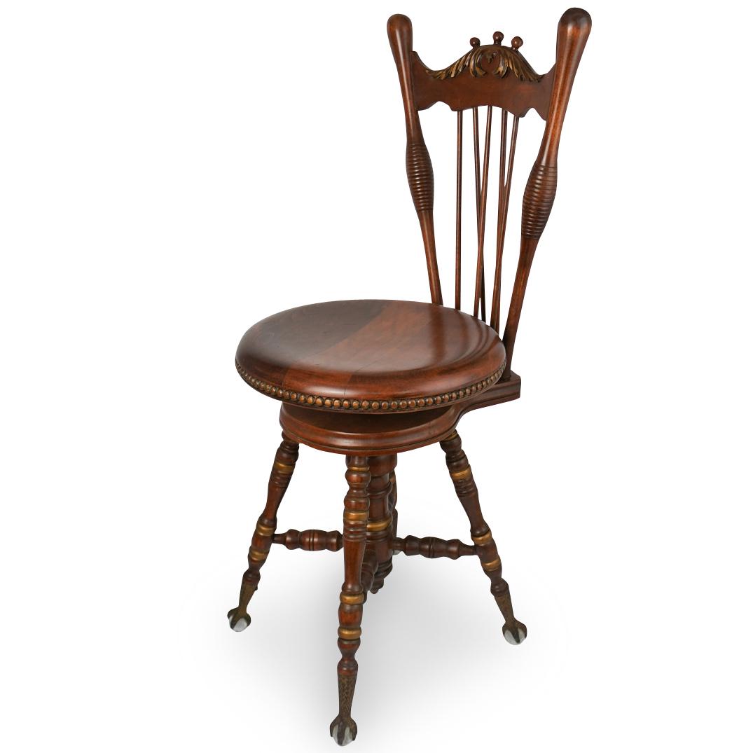 Antique Claw & Ball Footed Piano Chair: DESCRIPTION: An antique piano swivel wood chair with claw and ball feet. CIRCA: 20th Ct. ORIGIN: Continental DIMENSIONS: H: 36.5" x D: 17.5" CONDITION: Great condition. See lot description for details