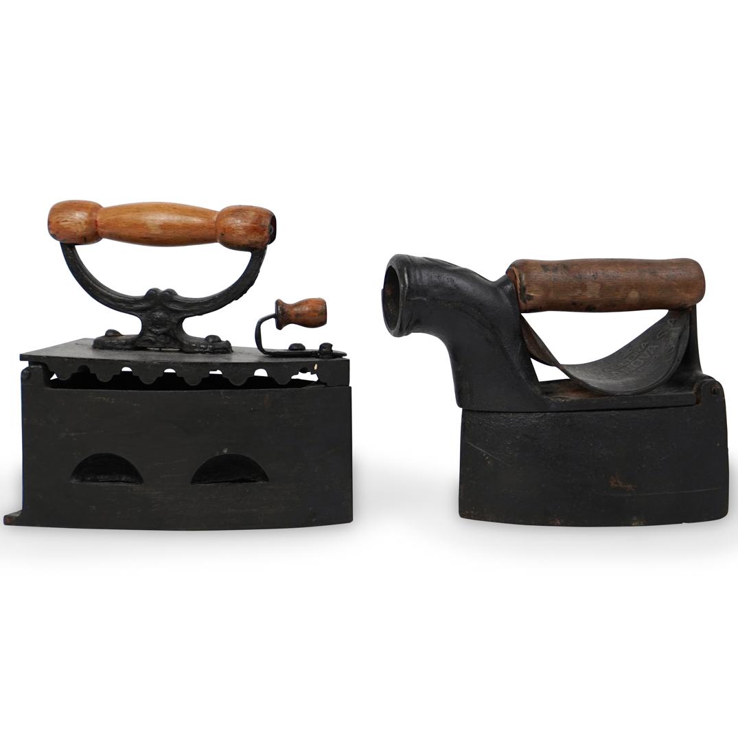 (2 Pc) Antique Clothing Irons: DESCRIPTION: (2 Pc) Antique clothing irons with wood handles. CIRCA: 19th Ct. ORIGIN: South America DIMENSIONS: (H: 8" x W: 3.75" x L: 8") & (H: 5.5" x W: 3.75" x L: 8") CONDITION: Great condition. Se