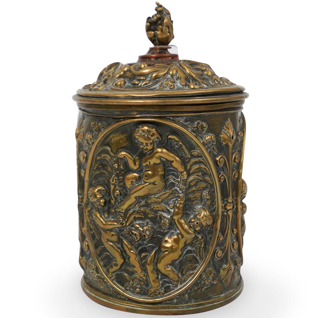 Antique Brass Repousse Humidor: DESCRIPTION: Antique Brass Repousse tobacco Humidor. Highly decorated with floral decorations and figural motifs. Finished with a flame finial.Ã‚ CIRCA:19th Ct. ORIGIN: England DIMENSIONS: H:7" 4.2