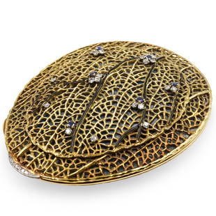 Rene Kern 18kt Gold Compact Case: A 18kt yellow gold compact case by Rene Kern featuring a reticulated branch design top with black enamel and approx 1ct in diamonds and 0.5 cts in in sapphires finished with a platinum diamond clasp.