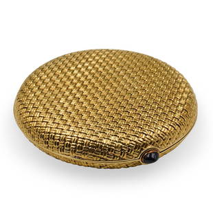 18k Gold Van Cleef & Arpels Compact Case: A vintage 18 karat yellow gold ladies compact case by Van Cleef & Arpels Featuring a woven design pattern in a round shape finished with a sapphire clasp. The interior has its original beveled