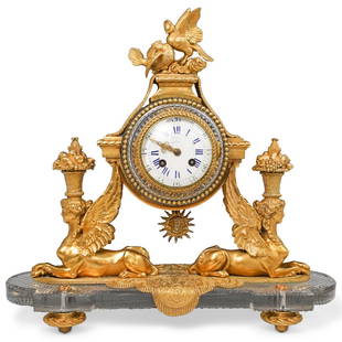 19th Cent Baccarat Crystal and Ormolu Mantel Clock: 19th Cent Baccarat Crystal and Ormolu Mantel Clock. Hand-chiseled ormolu and crystal glass barrel-form clockcase, is supported by two exceptionally gilded basket-bearing winged sphinxes. The clock is