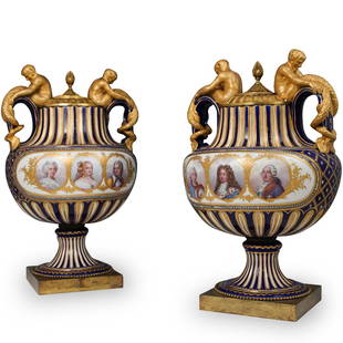 Pair of Monumental Sevres Royal Urns: Pair of extremely rare Sevres hand painted porcelain and ormolu urns. Features overall cobalt blue base color and gilded floral enamel detailing. One vase has hand painted portrait depictions of