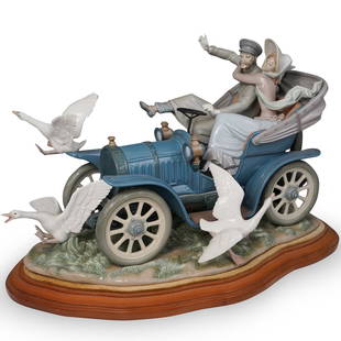 Lladro "Car In Trouble" Porcelain Sculpture: A Large Lladro porcelain group titled "Car In Trouble" #1375 Sculpted by Salvador Debon. Marked along the side with artists name and Lladro stamp No.34" sits atop a wooden base. CIRCA: 20th Ct.