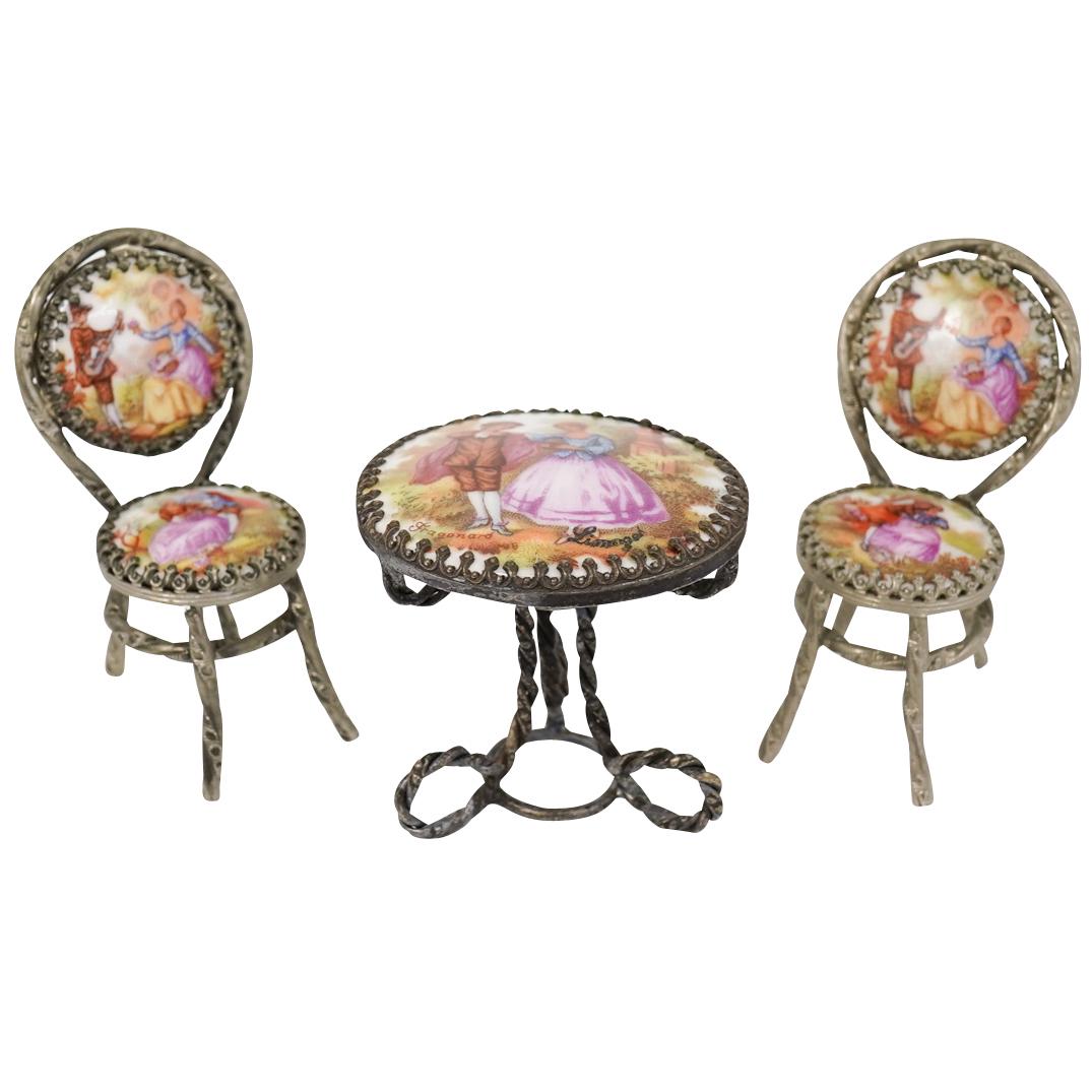 Miniature French Limoges Parlor Set: A miniature French Limoges hand painted parlor set composed of brass and porcelain, depicting scenes of courting couples. Marked "Limoges" CIRCA: 20th Ct. ORIGIN: France DIMENSIONS: (Table) H: 1.75" x