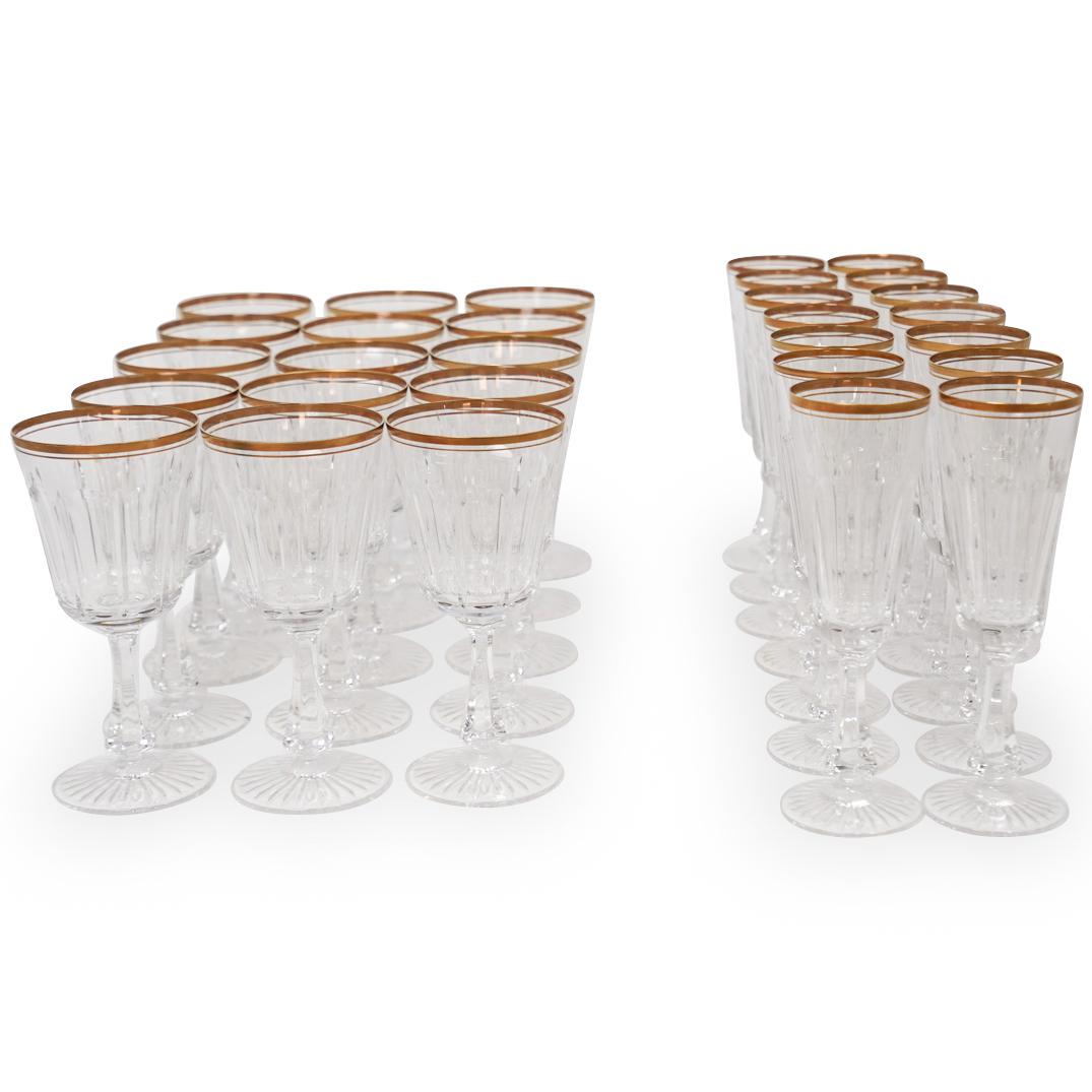 (29 Pc) French Parcel Gilt Crystal Glass Stemware: A set of 29 French parcel gilt crystal glass stemware. Features a gilded room and is composed of: 15 red wine glasses 14 champagne flutes. CIRCA: 20th Ct. ORIGIN: France DIMENSIONS: (Wine) H: 7.25" x 