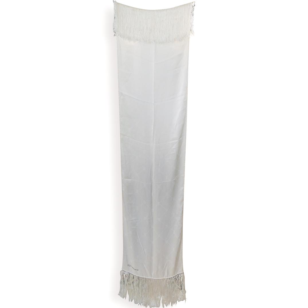 Cartier Must De Tassel Scarf: An off white Cartier scarf decorated with the double "C" monogram along the body, completed on either end with tassels. Printed along the bottom right "Must De Cartier Paris" CIRCA: Late 20th Cent. OR