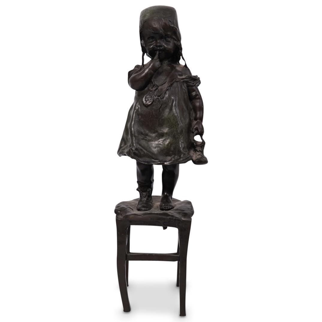 Juan Clara Bronze Sculpture: A bronze sculpture of a young girl by Juan Clara Ayats (Spanish, 1875-1958) depicts a young girl standing on a stool, inscribed on stool "Juan Clara" CIRCA: Early - Mid 20th Century ORIGIN: Spain DIME