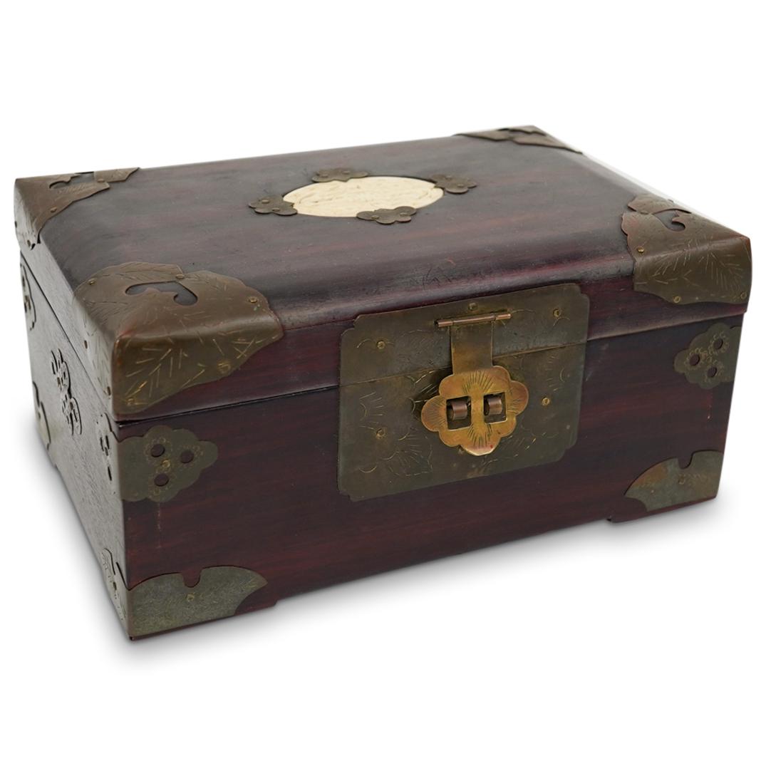 Chinese Wood Jewelry Box: DESCRIPTION: A Chinese wood jewelry box fitted with brass mounted accents and reticulated bone center medallion, interior further decorated with floral motif silk lining and ring tray insert.CIRCA: 20