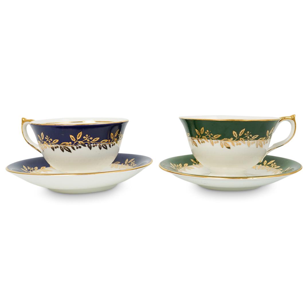 4 Aynsley Porcelain Tea Cup Set: DESCRIPTION: 4 Piece Ansley porcelain tea cup set featuring green and blue tea cups with fruit motifs finished with gilt wrapped wreath details along the outside. Includes matching porcelain saucers, 