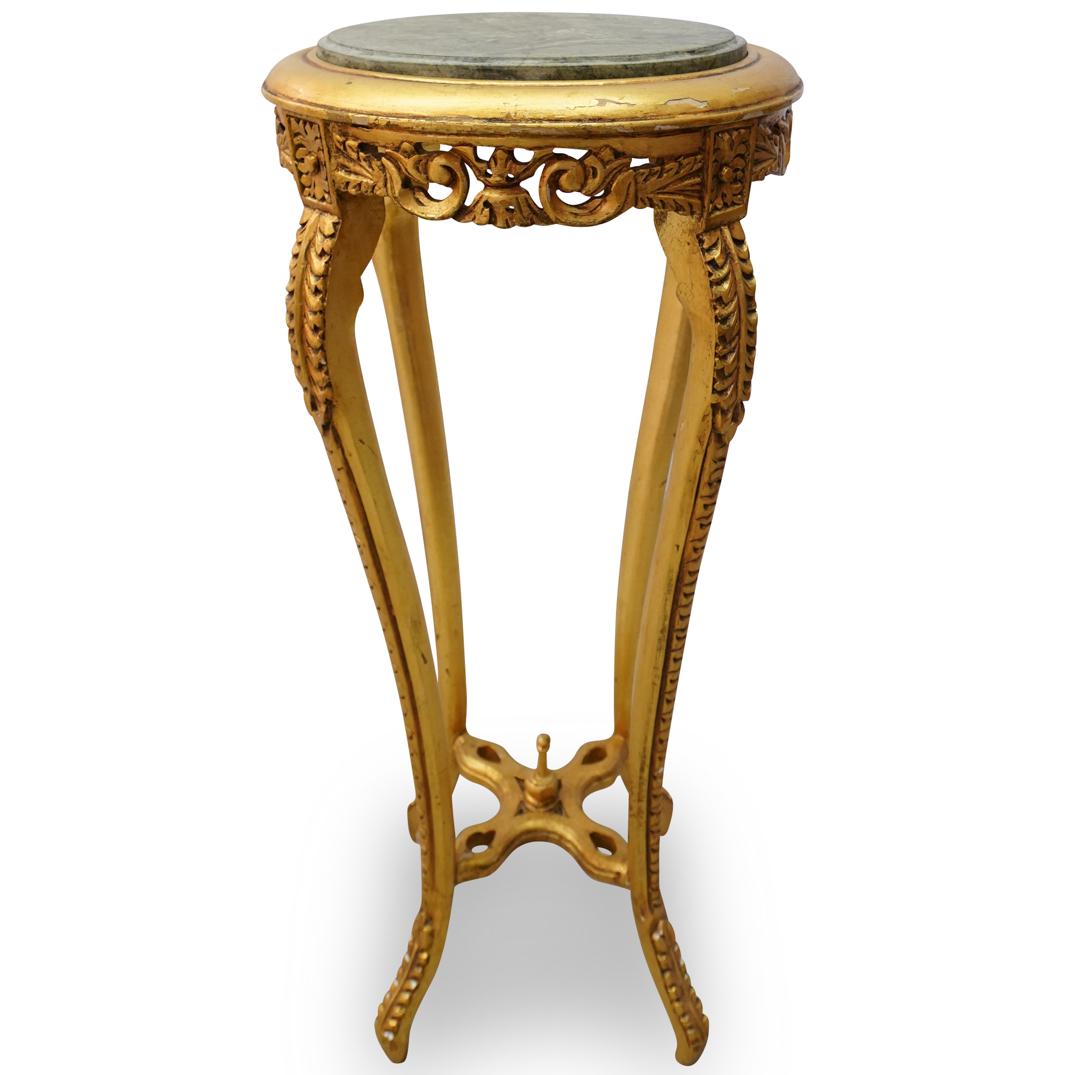 Antique Giltwood & Stone Pedestal: DESCRIPTION: An antique pedestal with hand carved giltwood and baroque scroll designs. Finished with an grey inlaid round stone top. CIRCA: Early to Mid 20th Ct. ORIGIN: Italy DIMENSIONS: H: 35" x D: