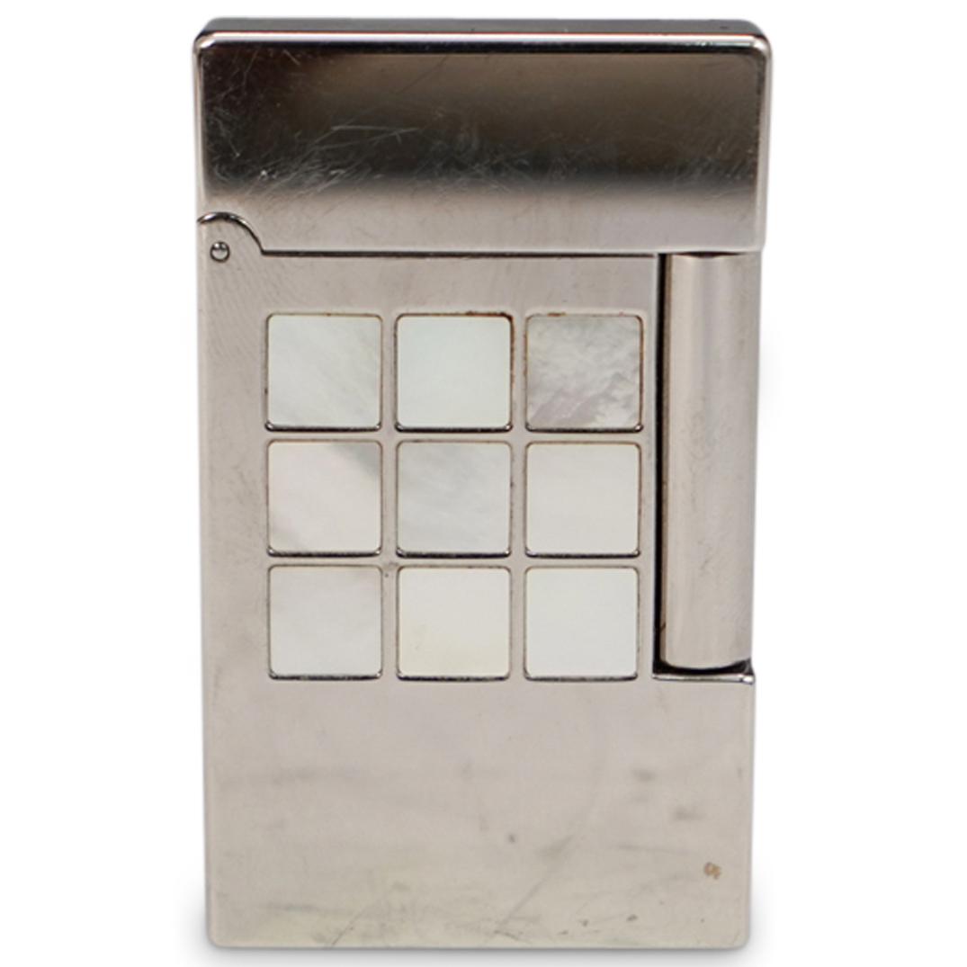 S.T. Dupont Silver Plated Pearl Lighter: DESCRIPTION: S.T. Dupont silver plated mother of pearl inlaid lighter. Marked on bottom " S.T. Dupont, Paris, Made In France" CIRCA: 20th Ct. ORIGIN: France DIMENSIONS: H: 2.5" x W: 0.25" x L: 1.5" CO