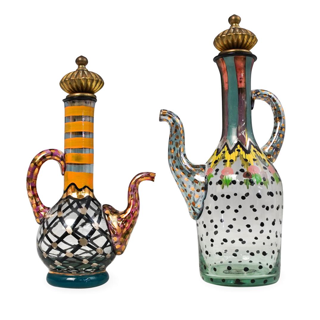 Pair of MacKenzie-Childs Victoria and Robert Glass: DESCRIPTION: Pair of MacKenzie-Childs Victoria and Robert Glass Cruets. Pair includes: (1) MacKenzie-Childs Victoria and Robert small circus painted glass cruet. Features a cork top with a brass handl