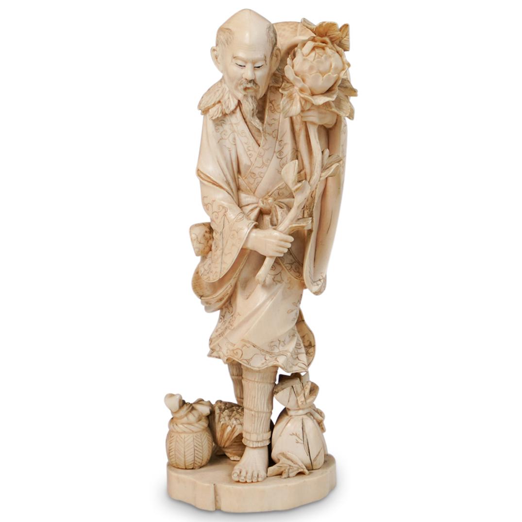 Antique Chinese Carved Bone Figure: DESCRIPTION: An antique Chinese bone carved figure. Features an intricately carved bone foundation depicting a bearded man in a vine accented robe holding a delicate flower. Mounted to oval base adorn