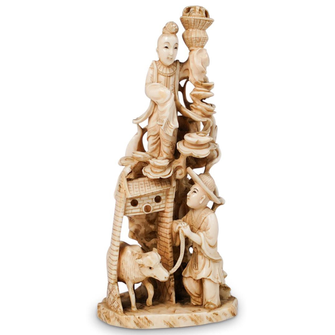 Antique Chinese Carved Bone Figure: DESCRIPTION: A antique bone carved Chinese figural statue. Features two bone carved figures one with cattle and the other with balancing a woven basket. Finished with a floral accents and a large scro
