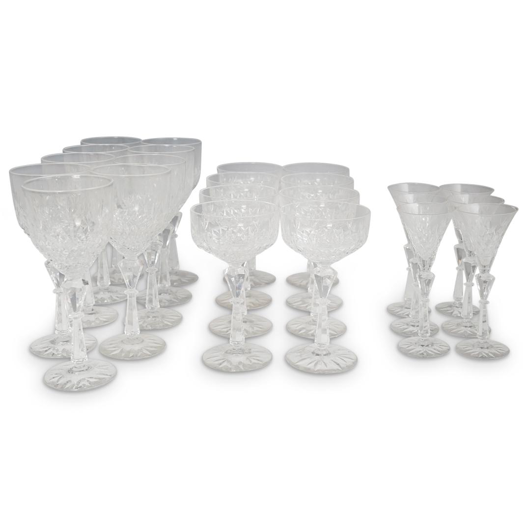 (24 Pcs) Set of Crystal Glasses: DESCRIPTION: (24 Pcs) Set of Crystal Glasses. Consists of 10 Red Wine Glasses, 8 Champagne Glasses and 6 shot glasses. Decorated along the body with a cut crystal design and finished with a multifacet