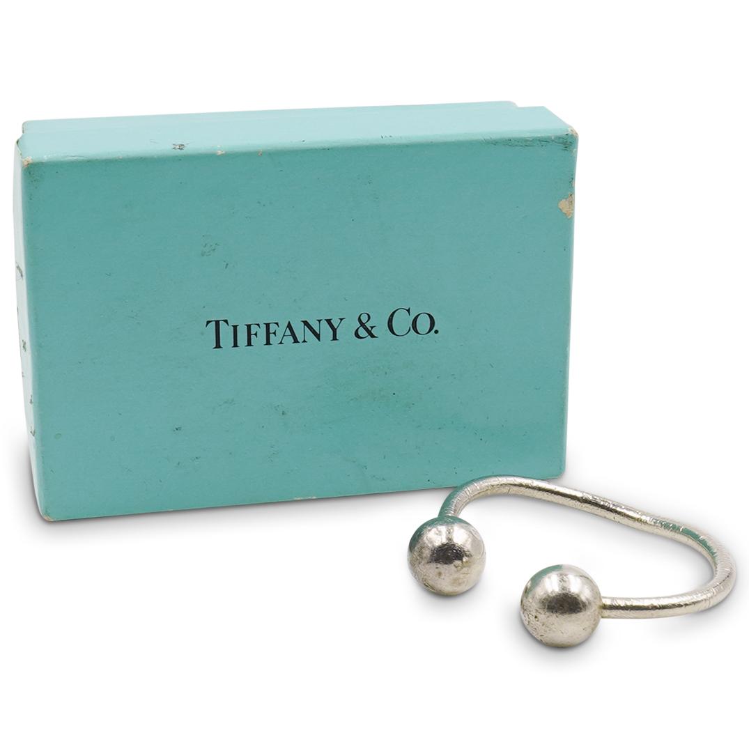 Tiffany and Co. Sterling Silver Keychain: DESCRIPTION: Tiffany and Co. sterling silver keychain. Comes with box and dustbag. Stamped "Tiffany and Co. 925" Total Weight: 15.6 g CIRCA: Late 20th - 21st Century ORIGIN: USA DIMENSIONS: D 2.0" CON