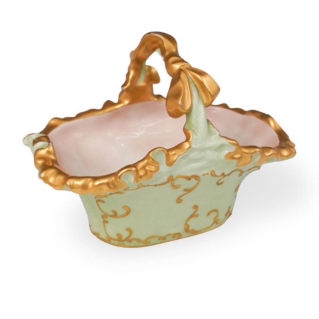Antique Limoge Porcelain Basket: DESCRIPTION: Antique Limoge Porcelain Basket. Features an overall mint green color with gilded scroll design throughout. Finished with a gilded ribbon motif handle. Marked "JPL Limoge France" CIRCA: 2
