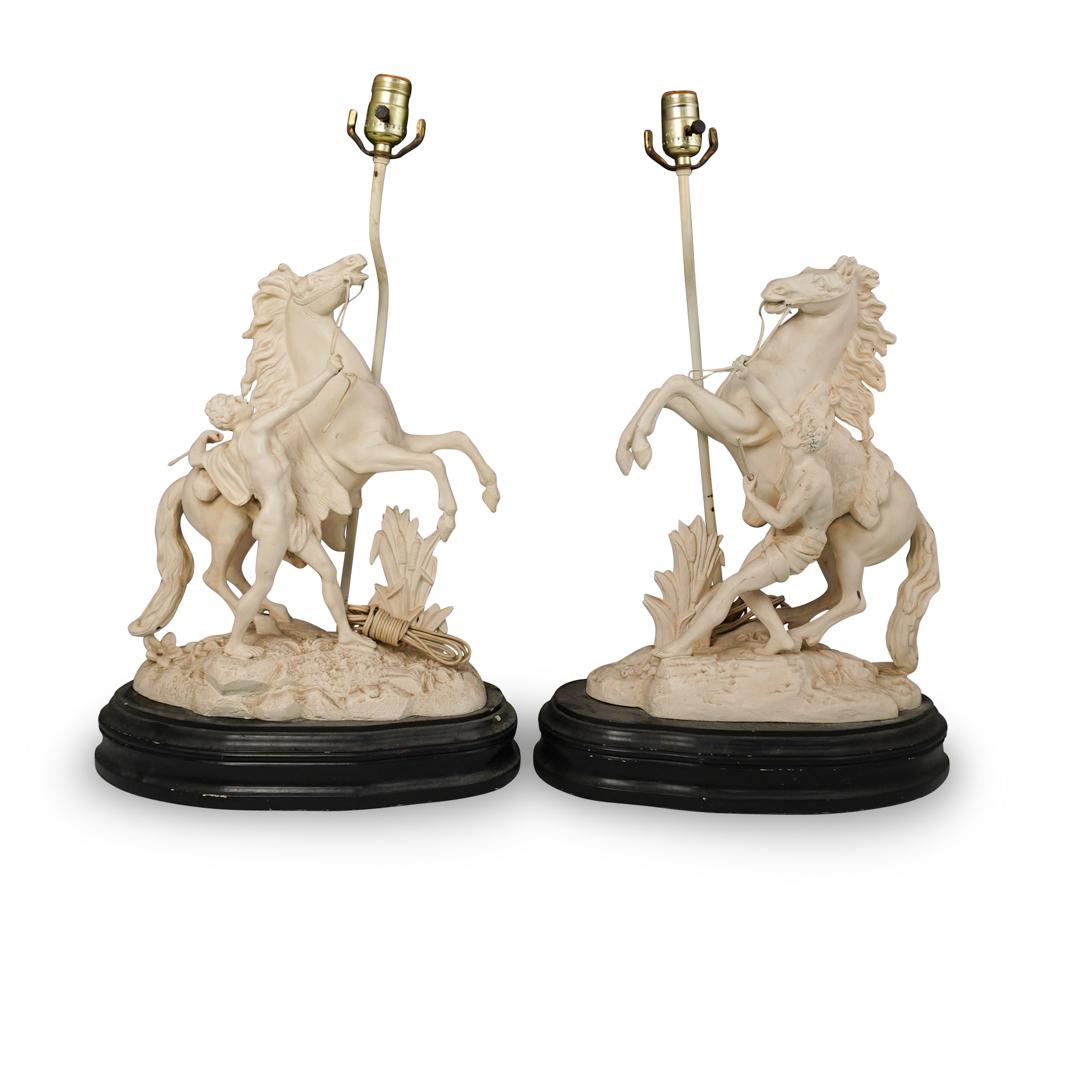 Marley Horses Metal Lamps: DESCRIPTION: A pair of antique French metal "Marly Horses" lamps. Cast after the original by Guillaume Coustou (1677-1746). Features Greco-Roman men taming wild standing horses, holding onto to the ho
