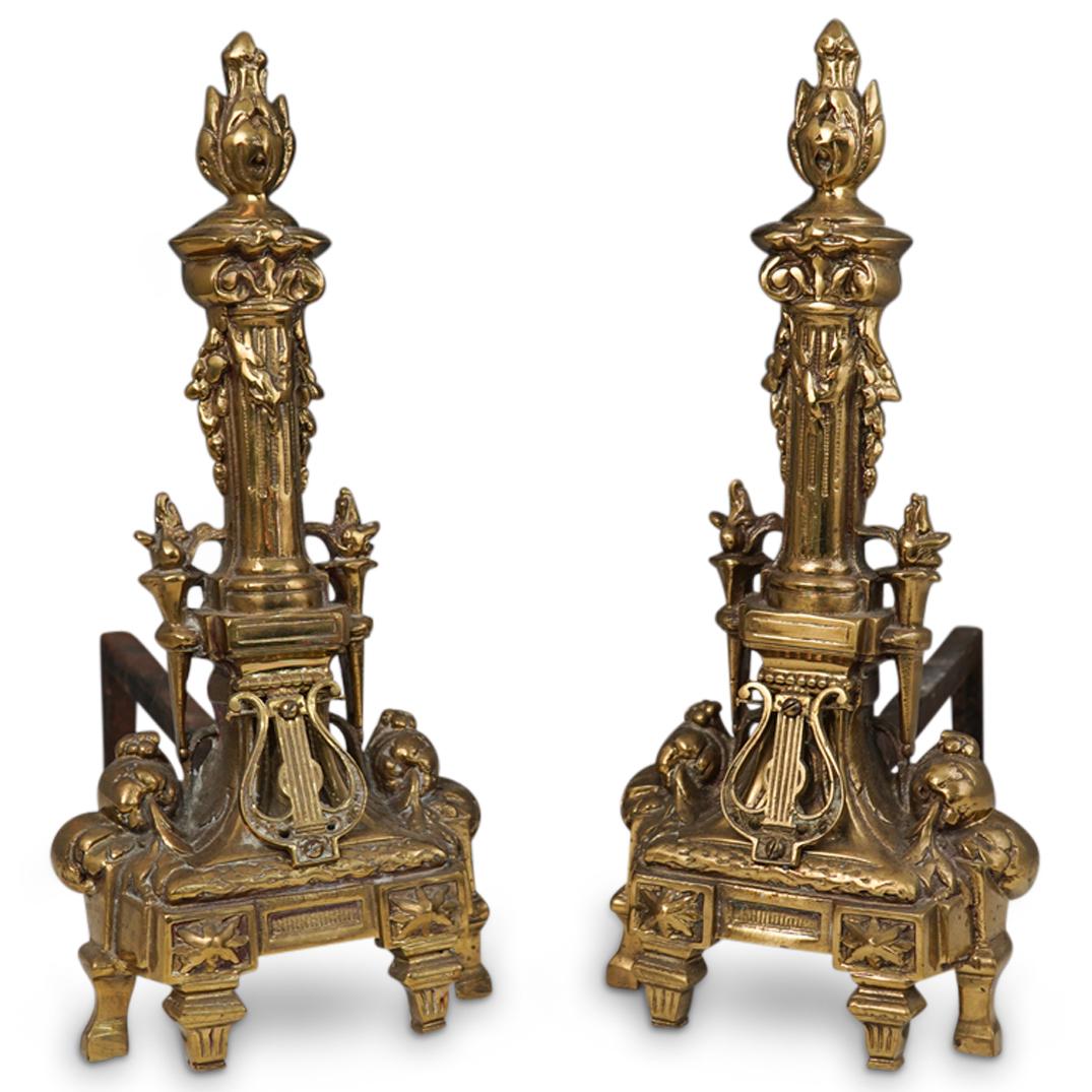 Pair Of Gilt Bronze Andirons: DESCRIPTION: A pair of gilt bronze Italian bravado style andirons. Featuring ornate details with flame motif finials. CIRCA: 20th Ct. ORIGIN: Italy DIMENSIONS: H: 17.5" x W: 8" x L: 17" CONDITION: Gre