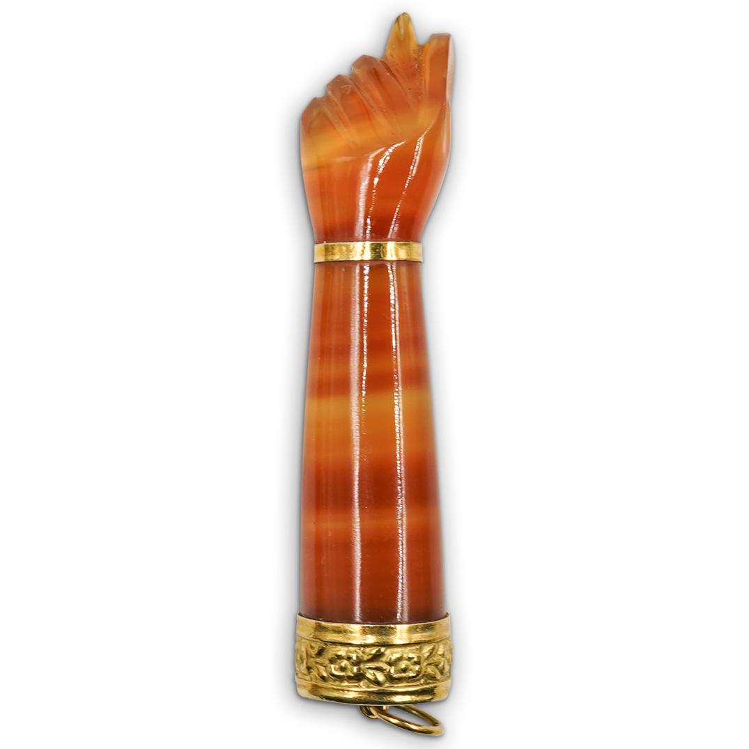 Italian 18k Gold and Carnelian Figa Charm: DESCRIPTION: An Italian 'Figa" Charm composed of Carnelian with 18k gold floral bordering, finished at the top with an attached bale. The Figa symbol means a call for fertility, virility and good time