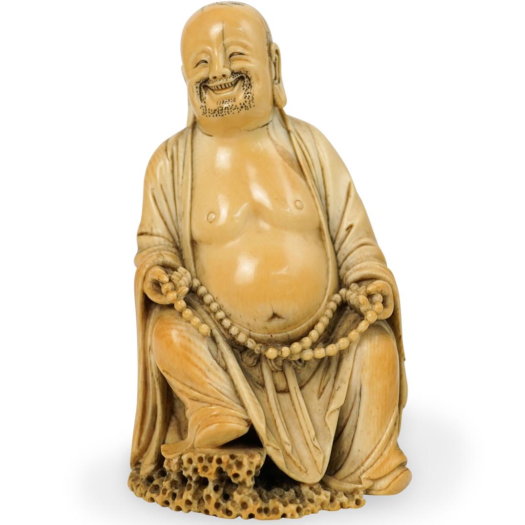 Antique Chinese Carved Bone Buddha: DESCRIPTION: An antique Chinese fine hand carved bone Buddha figure. Features an intricately carved laughing Buddha with draped robe details and stubble around his beard and head. Designed with figure