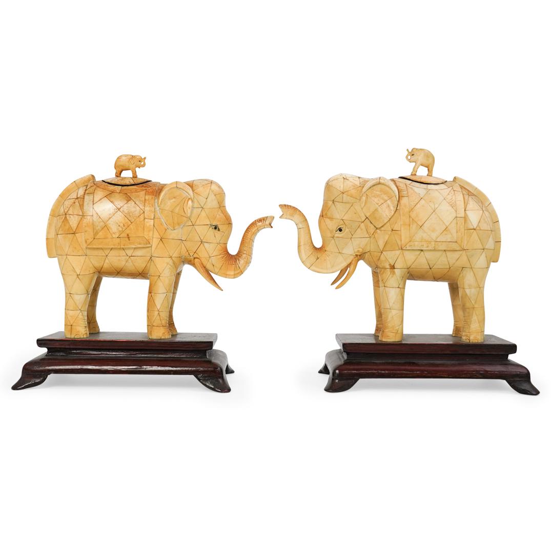 Pair Of Bone Elephant Urns: DESCRIPTION: A pair of bone elephant urns. Composed of a mosaic triangular bone structures depicting elephants with trunks raised. Fitted with lidded top cavity adorned with a small carved elephant fi