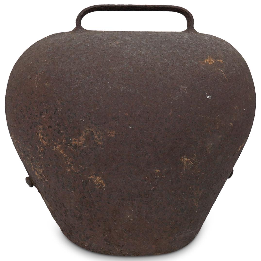 Large Swedish Cowbell: DESCRIPTION: Large Swedish cowbell composed of metal fitted with a metal handle at the stop. The cowbell features a rusted patina. Stamped "Morier Morges 5" CIRCA: 19th Century ORIGIN: Sweden DIMENSIO