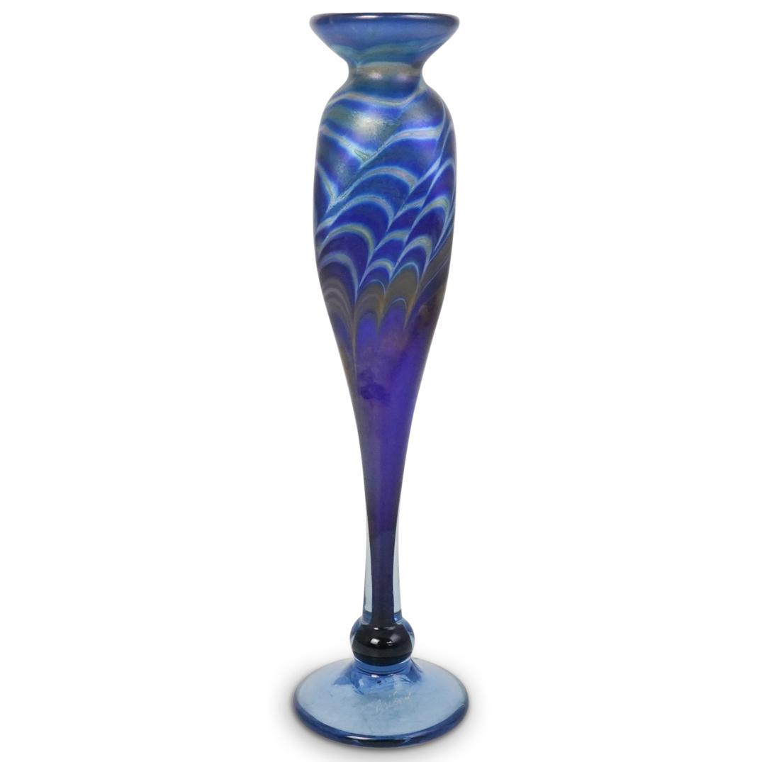 Brioni Signed Art Glass: DESCRIPTION: Brioni signed art glass. Features an iridescent blue glass designed body with tapered stem, rising from a disk and ball form base. Finished with a flared rim and etched signature "Brioni"