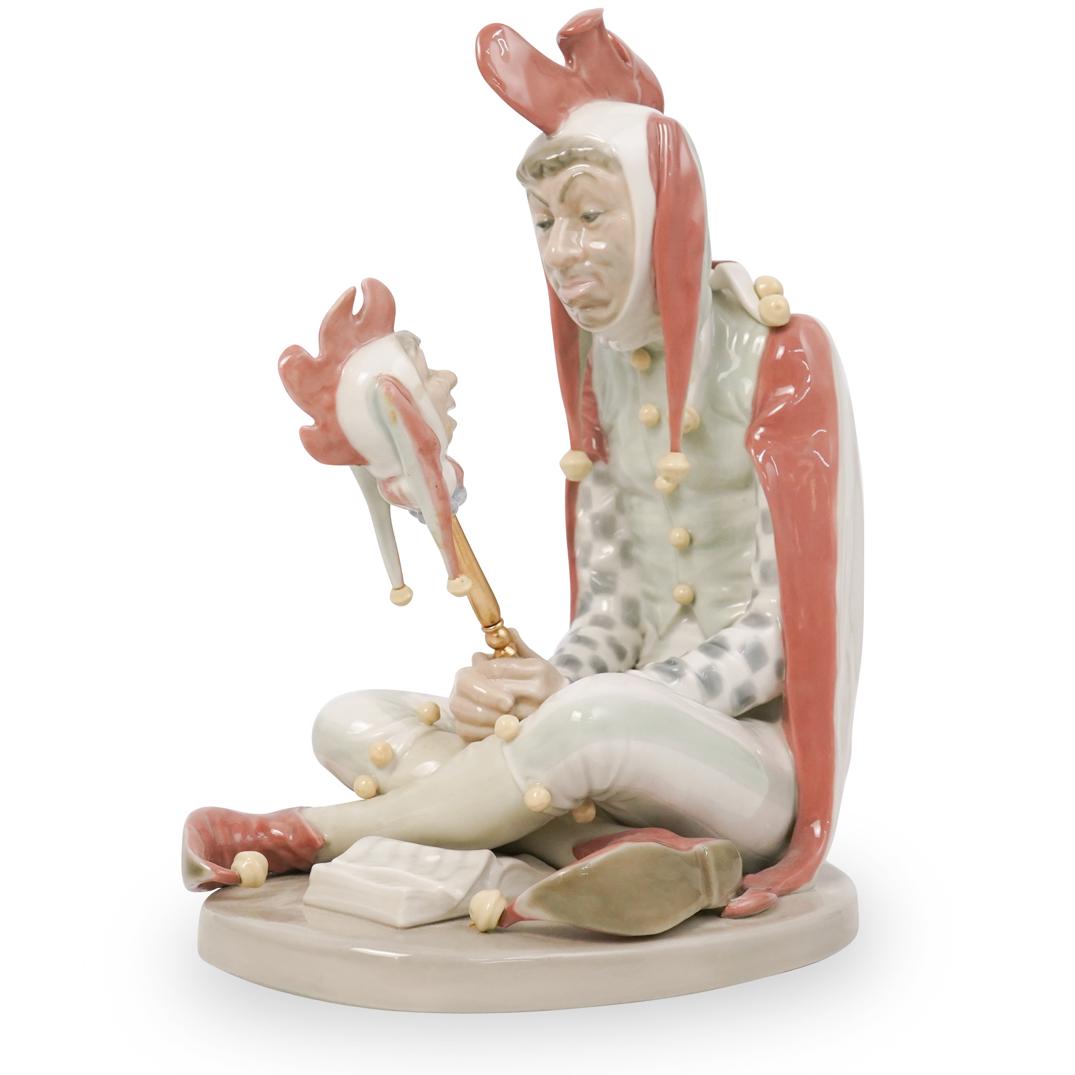 Lladro Chicken Suit Figurine: DESCRIPTION: Lladro porcelain figurine depicting a man in a chicken suit holding a head on a stick. Finished with a glossed glaze and marked on the bottom with Lladro blue stamp. CIRCA: 20th Ct. ORIGI