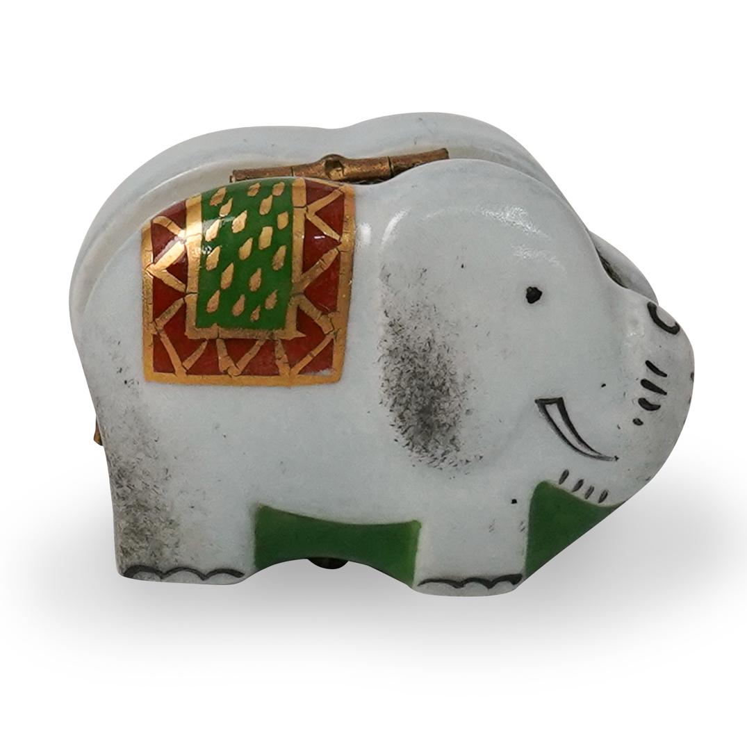 Limoges Porcelain Elephant Pill Box: DESCRIPTION: Limoges porcelain pill box in the shape of an elephant with a grey hue and gilt accents. Signed "Limoges" underneath CIRCA: 20th Century ORIGIN: France DIMENSIONS: H 1.0" x W 2.0" CONDITI