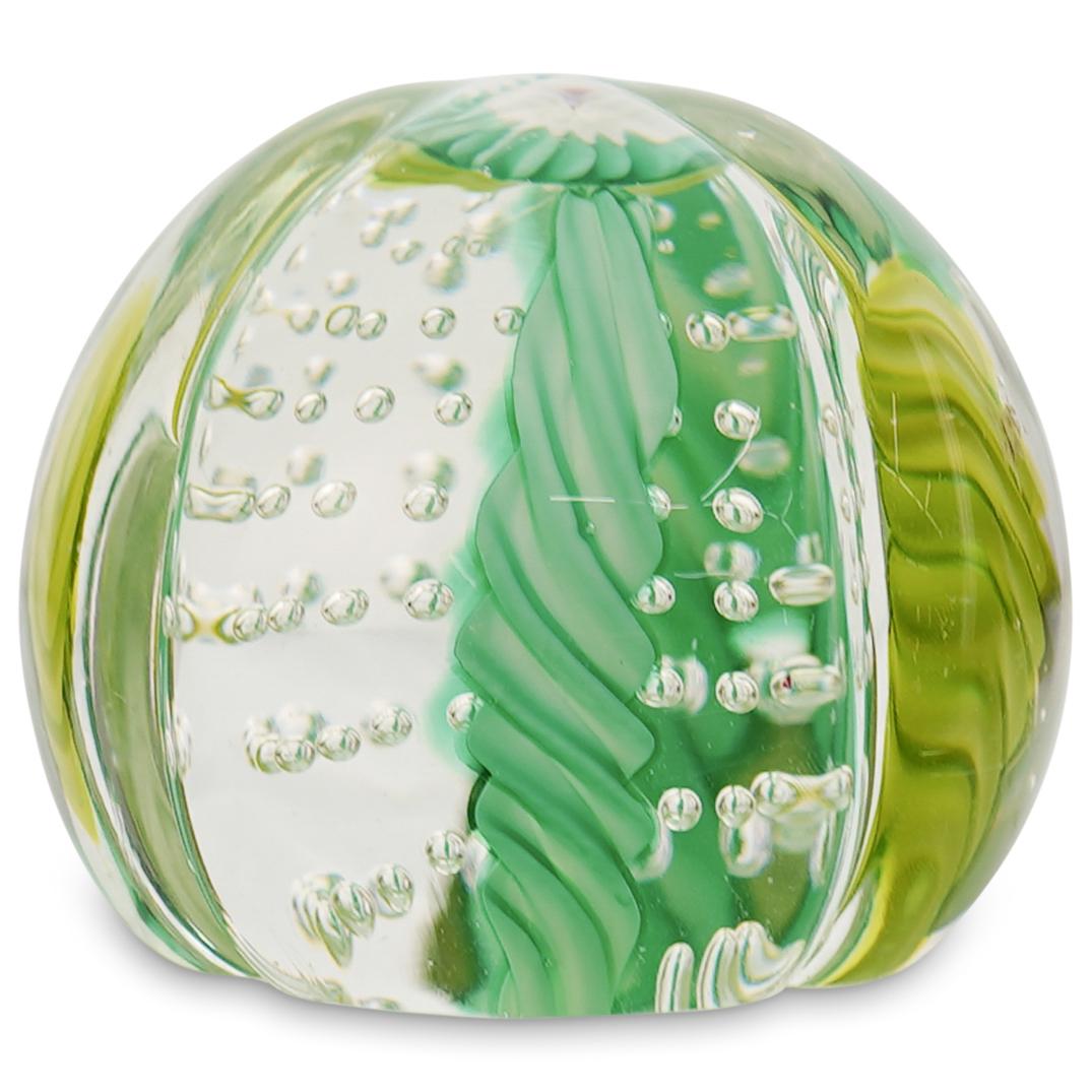 Murano Glass Paperweight: DESCRIPTION: A Murano glass paperweight features a ribbed design along the body, embellished along the interior with yellow and green hues with controlled bubbles. Stickered Made In Murano Italy. CIRC