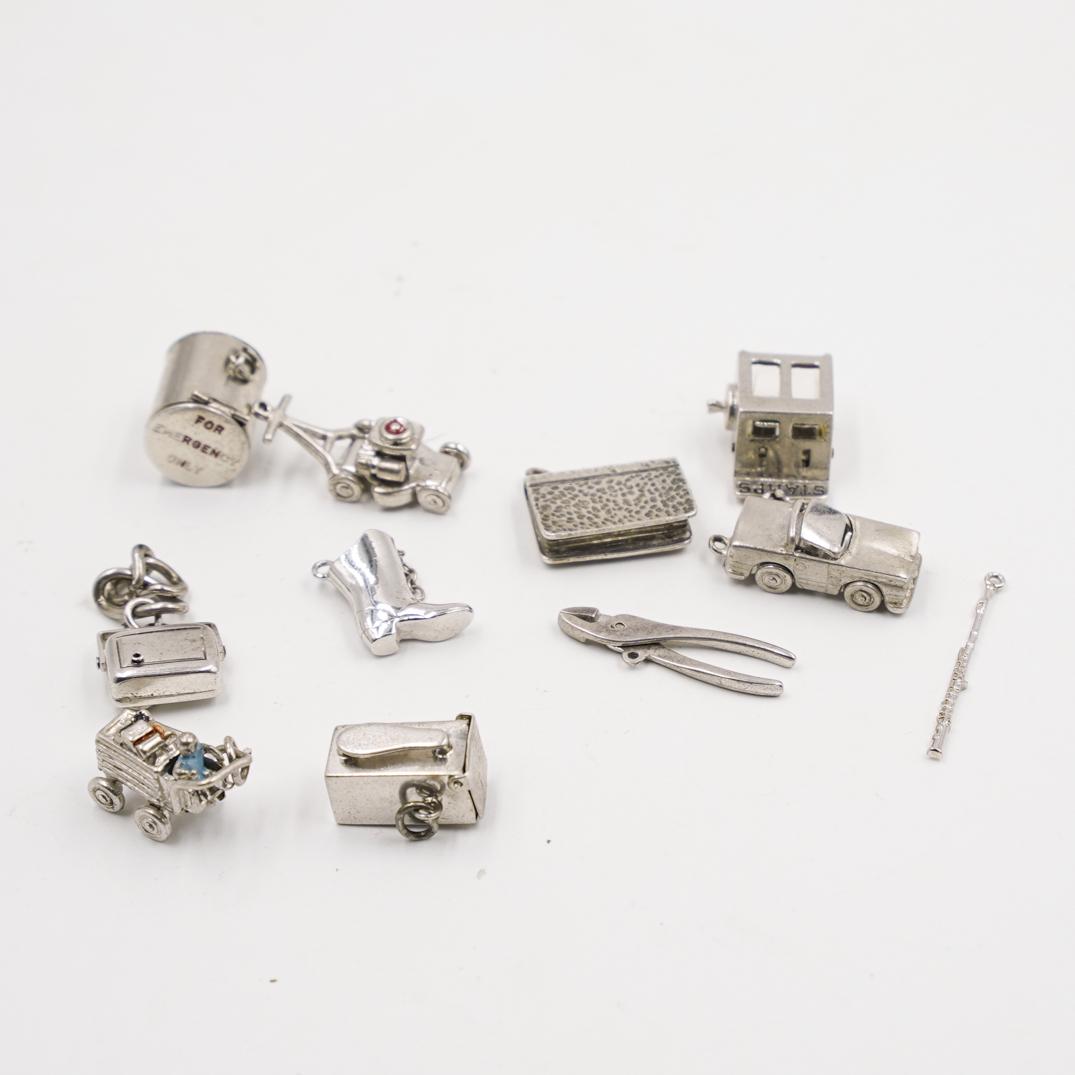 (11Pc) Sterling Silver Charms: DESCRIPTION: (11 Pc) A grouping of (11) sterling silver charms. Features a cash register, car, tracktor, plyers, radio, boot, ect. Marked "Sterling" Total Weight: 42 Grams CIRCA: 20th Ct. ORIGIN: USA