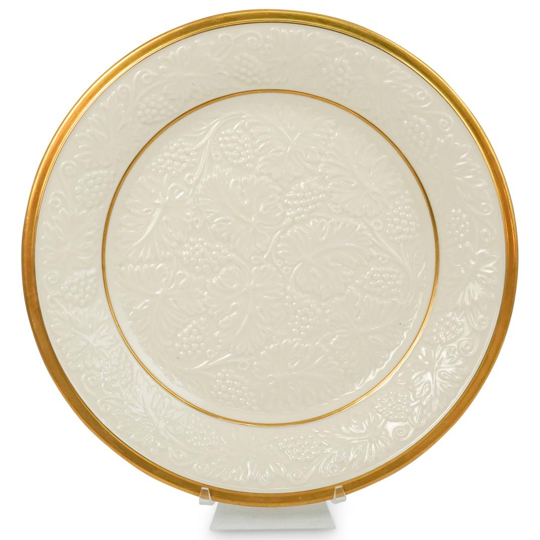Lenox Porcelain Gilt Plate: DESCRIPTION: Lenox porcelain plate adorning raised floral motif going across the plate, as well as gilt trimming around the rim and center. Marked "Lenox" underneath. CIRCA: 20th Century ORIGIN: USA D