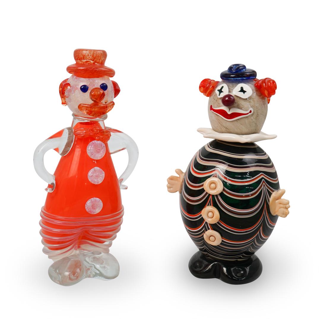2 Murano Hand Blown Glass Clowns: DESCRIPTION: A lot of 2 Muno hand blown glass clowns. The heavier clown is signed SD 2002 on the bottom. CIRCA: 2002 ORIGIN: Italy DIMENSIONS: approx H;13" by L;4" CONDITION: Great condition. See lot 