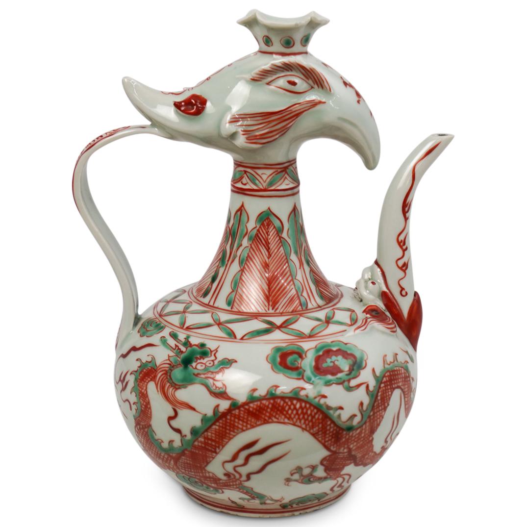 Antique Chinese Porcelain Phoenix Wine Pot: DESCRIPTION: An antique Chinese porcelain phoenix motif wine pot. Features red and green painted detailed design with dragons and clouds throughout the body. Finished with a curved handle, feather dec