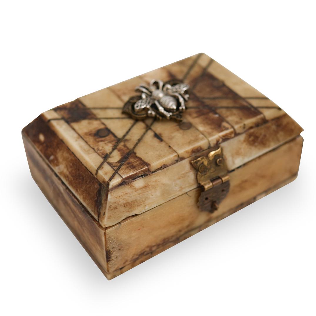 Antique Bone & Brass Box: DESCRIPTION: An antique polished bone box. Features a polished bone foundation with hammered brass hardware. Opens to reveal green fabric lined interior and finished with a mounted silver toned bumble