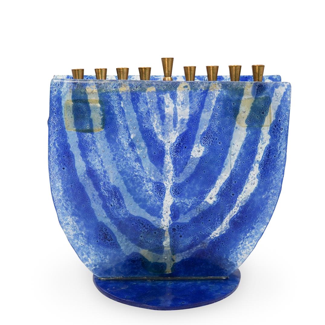 Art Glass Menorah: DESCRIPTION: Art Glass Menorah featuring brass candleholders black and clear stained glass foundation. CIRCA: 20th ORIGIN: Israel DIMENSIONS:H:8" W:8" CONDITION: Great condition. See lot description f