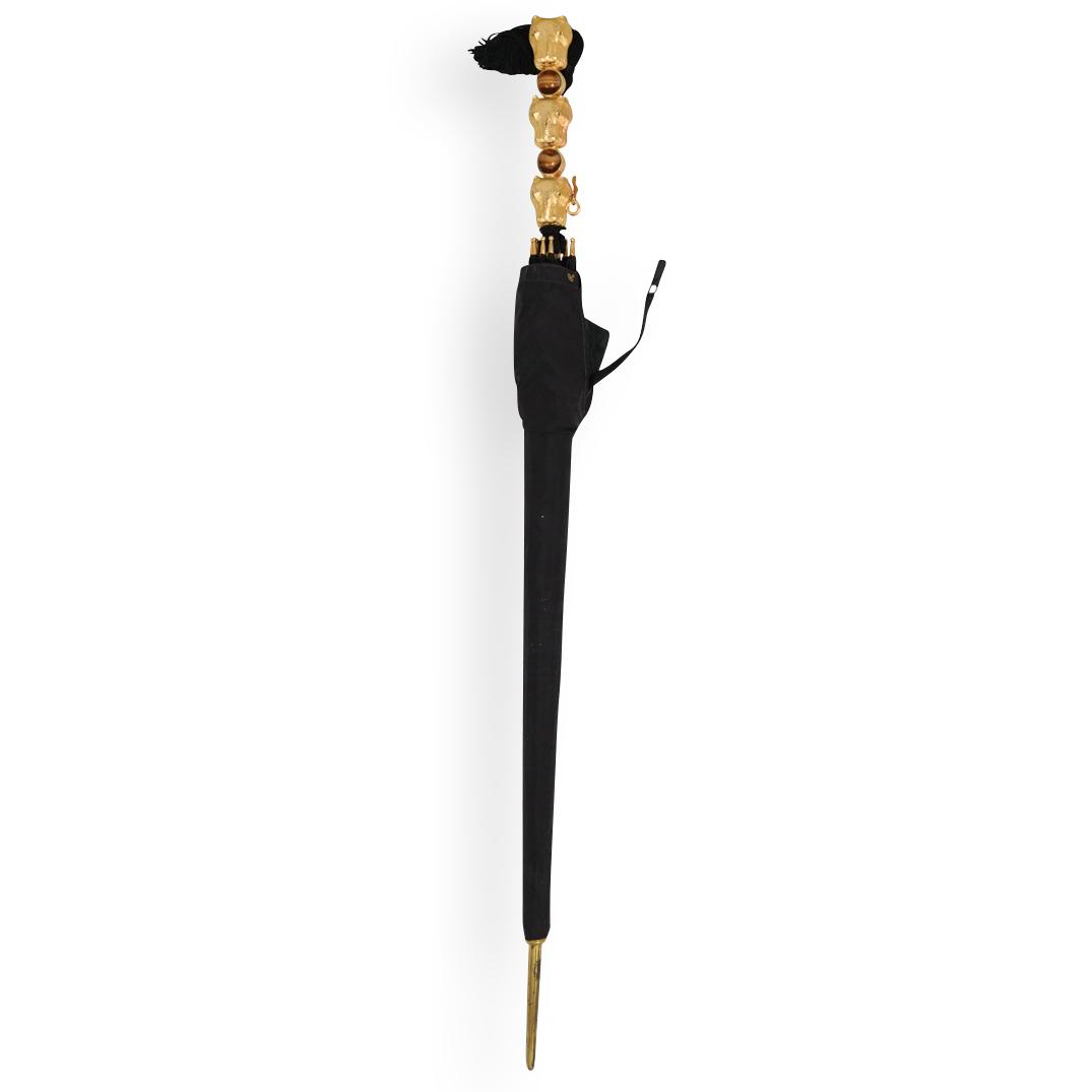 Vintage Judith Leiber Hippo Umbrella: DESCRIPTION: A Vintage Judith Leiber gilt hippo motif umbrella. Features a gilt metal hippo head motif handle, adorned with glass marble accents. Further designed with a black nylon rain shield dome.