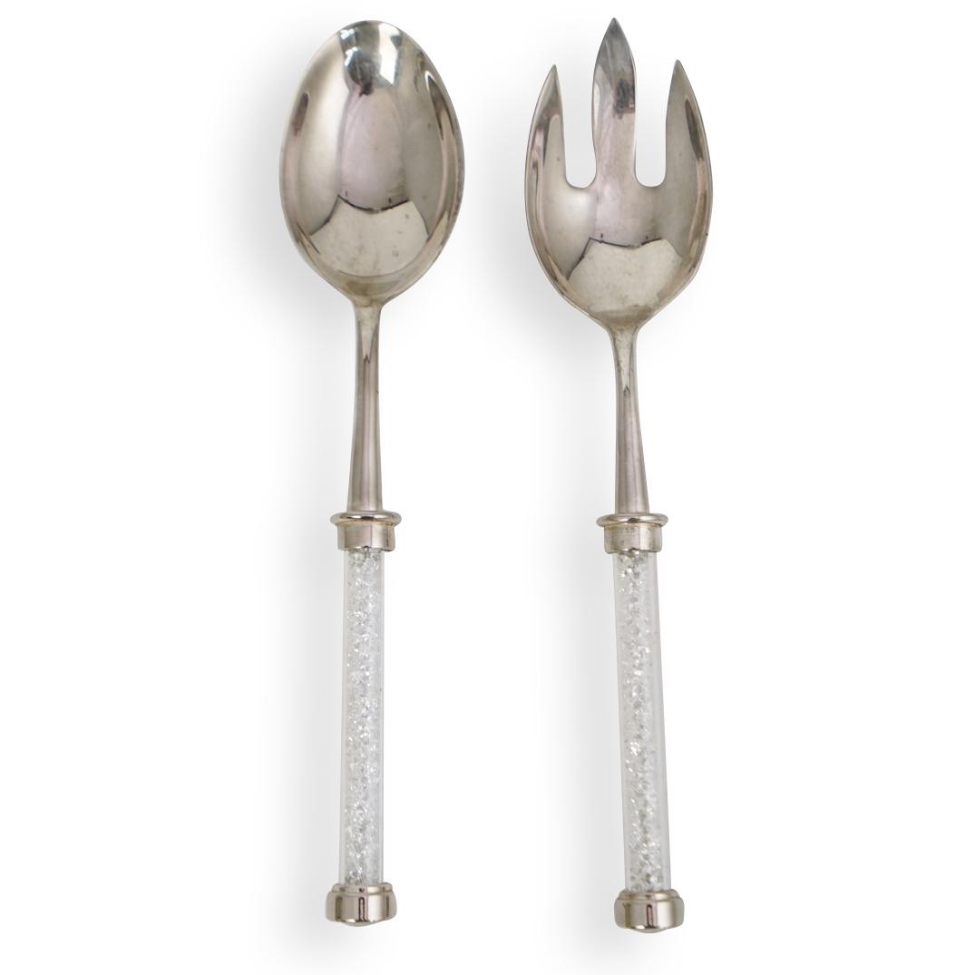 Swarovski Crystal filled Serving Utensil Set: DESCRIPTION: A Swarovski crystal filled serving utensil set. Features two stainless steel serving spoons with crystal filled handles. CIRCA: 20th Ct. ORIGIN: Austria DIMENSIONS: L: 10.5" x W: 2.25" CO