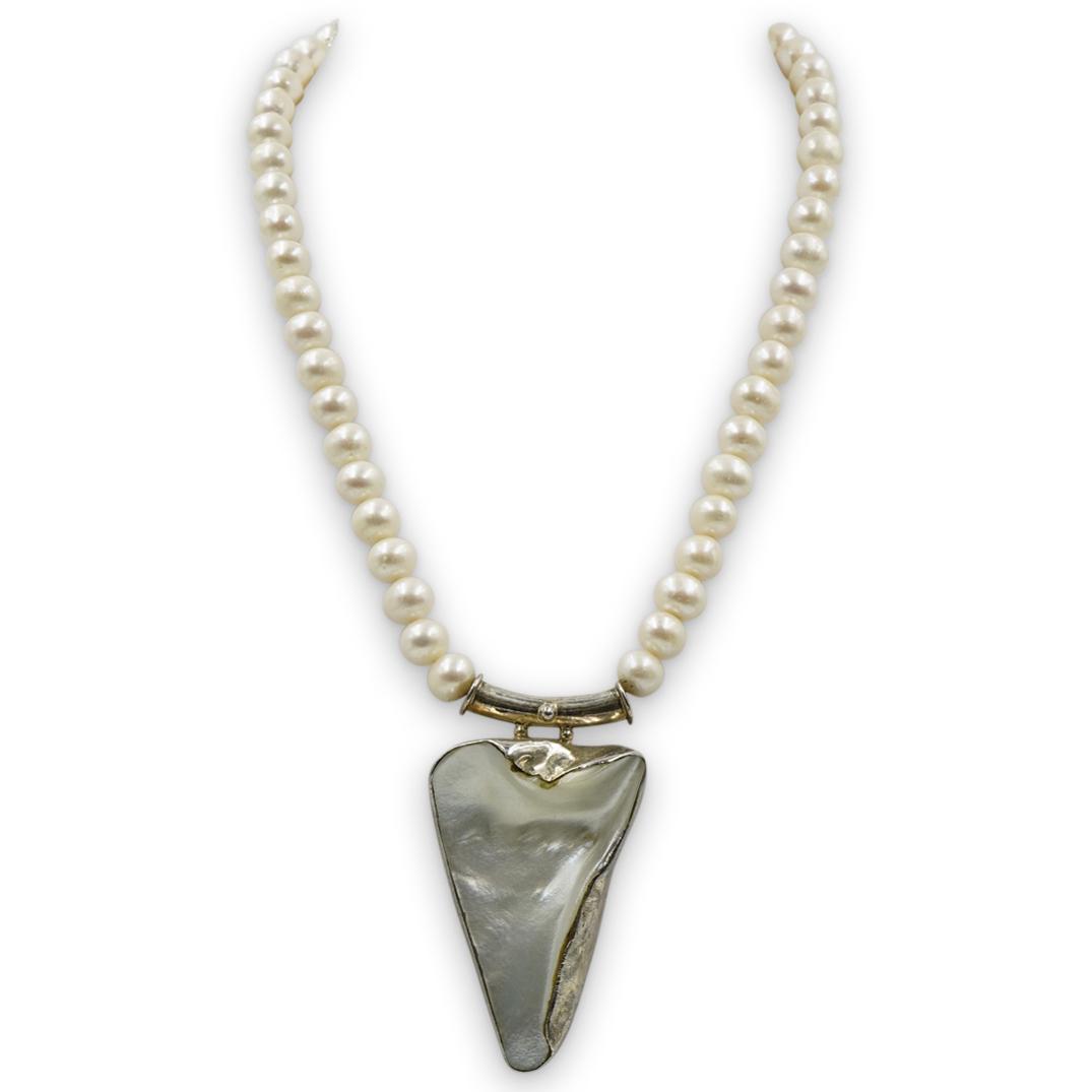 Sterling Silver and Pearl Pendant Necklace: DESCRIPTION: A Necklace composed of a beaded pearl necklace, centered by a seashell pendant enveloped by sterling silver. Completed with a swarovski crystal decorated clasp. CIRCA: 20th Cent. ORIGIN: 