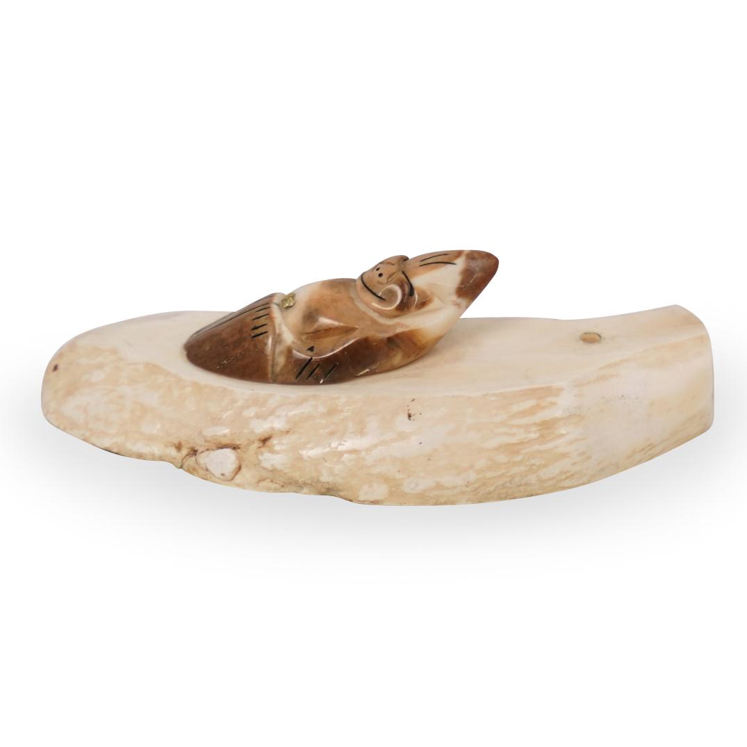 Sperm Whale Carved Bone and Gold Nugget Paperweight: DESCRIPTION: A Sperm Whale Inuit carved bone paperweight, features a carved figure centered by a small gold nugget, fitted atop a carved base. CIRCA: Earl 20th cent. ORIGIN: Inuit DIMENSIONS: H: 1.5" 